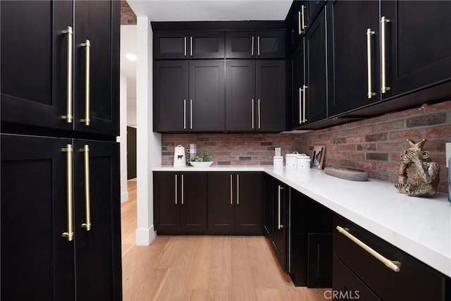 235 Verbena Ln, Brea, CA 92823 - kitchen with light wood-style floors, light countertops, and dark cabinets