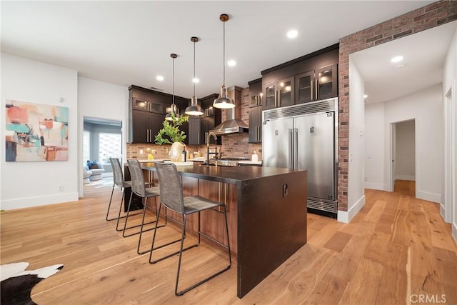 235 Verbena Ln, Brea, CA 92823 - kitchen with built in refrigerator, tasteful backsplash, light wood-style floors, a kitchen bar, and recessed lighting
