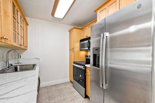 2850 Reynard Way Unit 10, San Diego, CA 92103 - kitchen with stainless steel appliances, light brown cabinetry, glass insert cabinets, light stone countertops, and light tile patterned flooring
