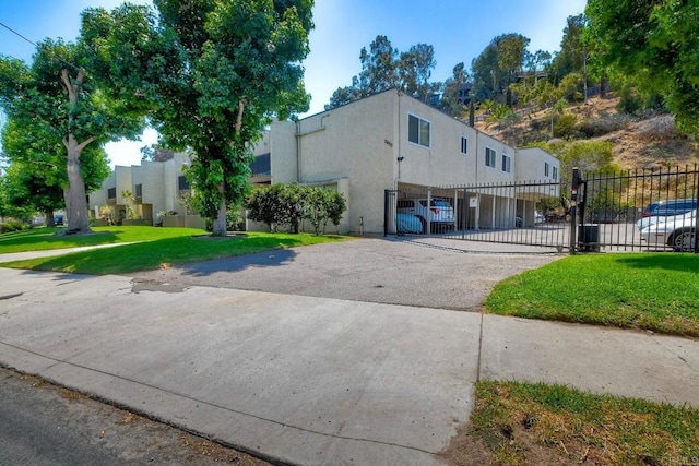 2850 Reynard Way Unit 10, San Diego, CA 92103 - view of front of property featuring stucco siding, a gate, a fenced front yard, and asphalt driveway