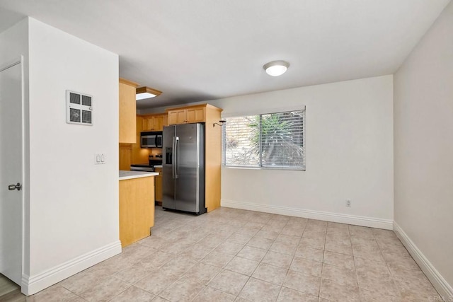 2850 Reynard Way Unit 10, San Diego, CA 92103 - kitchen with stainless steel appliances, light countertops, light tile patterned flooring, and light brown cabinetry