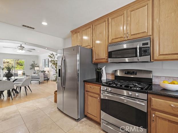 22601 Aguadero Pl, Saugus, CA 91350 - kitchen with appliances with stainless steel finishes, open floor plan, ceiling fan, light tile patterned flooring, and recessed lighting
