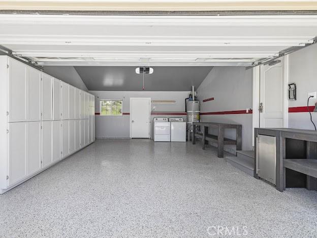 22601 Aguadero Pl, Saugus, CA 91350 - garage featuring washer and dryer, a garage door opener, and water heater