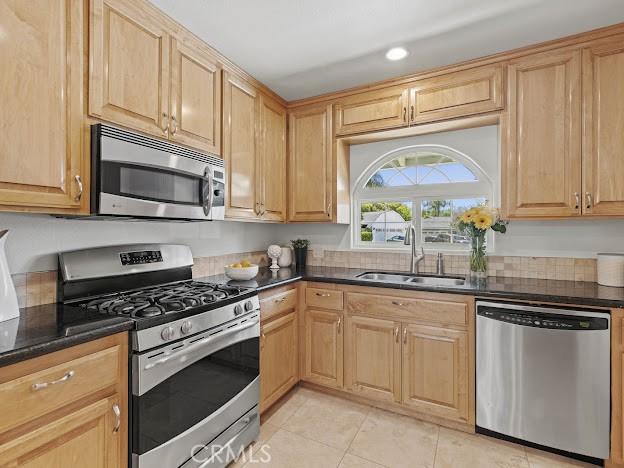 22601 Aguadero Pl, Saugus, CA 91350 - kitchen with stainless steel appliances, light tile patterned floors, light brown cabinets, and recessed lighting