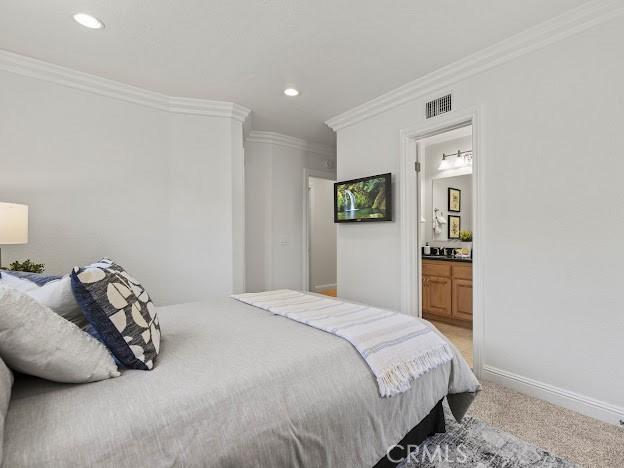 22601 Aguadero Pl, Saugus, CA 91350 - bedroom featuring crown molding, light colored carpet, recessed lighting, and connected bathroom