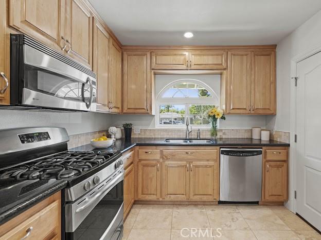 22601 Aguadero Pl, Saugus, CA 91350 - kitchen featuring appliances with stainless steel finishes, light tile patterned floors, and recessed lighting