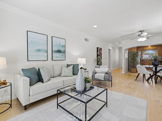 22601 Aguadero Pl, Saugus, CA 91350 - living room with ornamental molding, light wood-style floors, a ceiling fan, and recessed lighting