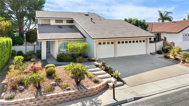 1317 Mill Creek Ct, Thousand Oaks, CA 91360 - view of front of house with an attached garage, driveway, stucco siding, and a tiled roof