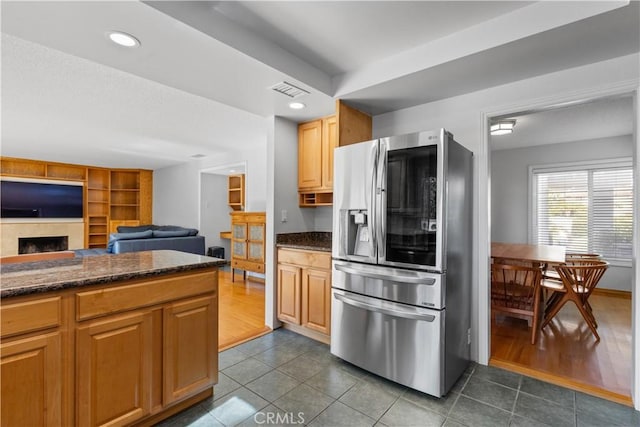 1317 Mill Creek Ct, Thousand Oaks, CA 91360 - kitchen featuring stainless steel refrigerator with ice dispenser, dark tile patterned floors, open floor plan, dark stone countertops, and recessed lighting