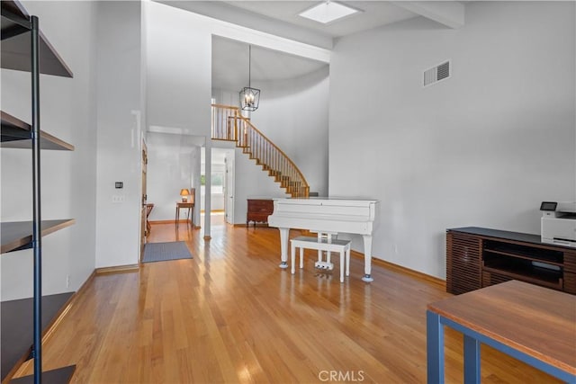 1317 Mill Creek Ct, Thousand Oaks, CA 91360 - entrance foyer featuring a high ceiling, wood finished floors, a chandelier, stairs, and beam ceiling
