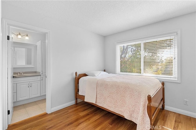 1317 Mill Creek Ct, Thousand Oaks, CA 91360 - bedroom with a textured ceiling, light wood-type flooring, and ensuite bathroom