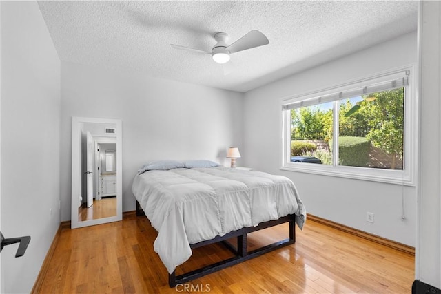 1317 Mill Creek Ct, Thousand Oaks, CA 91360 - bedroom featuring a textured ceiling, light wood-type flooring, and a ceiling fan
