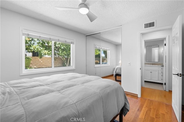 1317 Mill Creek Ct, Thousand Oaks, CA 91360 - bedroom featuring a textured ceiling, light wood-type flooring, a closet, and ceiling fan