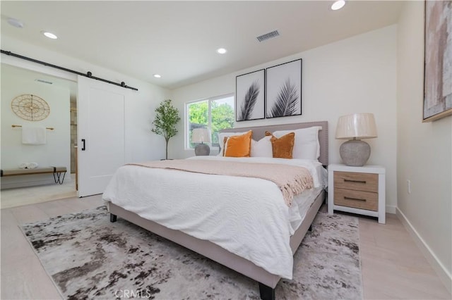 16645 Holton St, La Puente, CA 91744 - bedroom featuring a barn door, recessed lighting, and light wood-type flooring