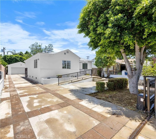 6846 Wystone Ave, Reseda, CA 91335 - view of front of property with a detached garage, stucco siding, driveway, and covered porch