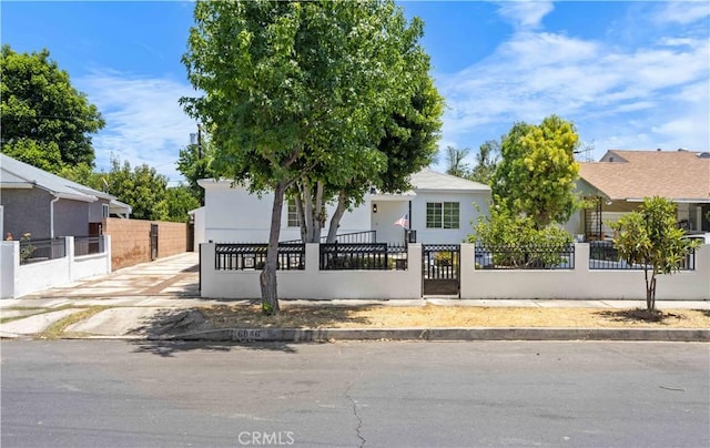 6846 Wystone Ave, Reseda, CA 91335 - view of property hidden behind natural elements with a gate, a fenced front yard, and stucco siding
