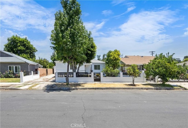 6846 Wystone Ave, Reseda, CA 91335 - view of property hidden behind natural elements featuring a fenced front yard, a gate, and stucco siding