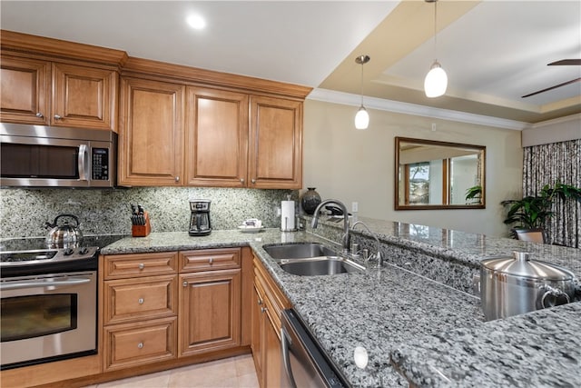 2727 Shell Beach Rd Unit 219, Pismo Beach, CA 93449 - kitchen featuring appliances with stainless steel finishes, brown cabinetry, light stone countertops, decorative backsplash, and a tray ceiling