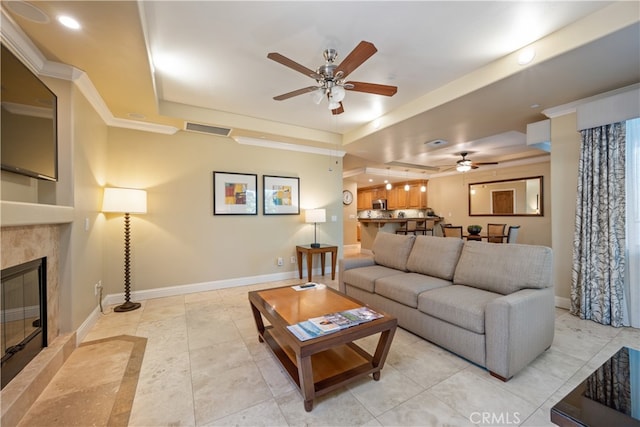2727 Shell Beach Rd Unit 219, Pismo Beach, CA 93449 - living area featuring a ceiling fan, a tray ceiling, a tiled fireplace, recessed lighting, and light tile patterned floors