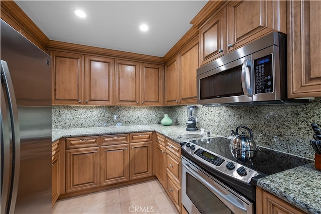 2727 Shell Beach Rd Unit 219, Pismo Beach, CA 93449 - kitchen with stainless steel appliances, brown cabinets, and tasteful backsplash