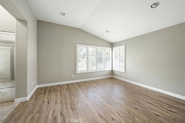 25623 Frost Ln, Stevenson Ranch, CA 91381 - empty room featuring light wood finished floors and vaulted ceiling