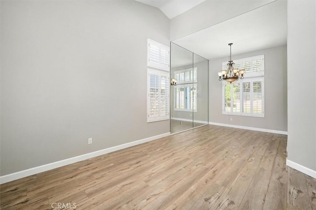 25623 Frost Ln, Stevenson Ranch, CA 91381 - spare room featuring a chandelier, plenty of natural light, light wood finished floors, and vaulted ceiling