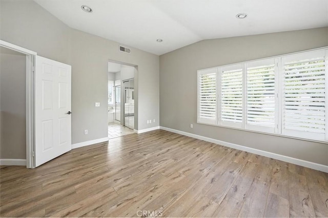 25623 Frost Ln, Stevenson Ranch, CA 91381 - unfurnished bedroom featuring light wood-style floors, lofted ceiling, and ensuite bathroom