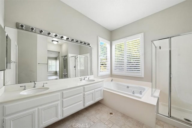 25623 Frost Ln, Stevenson Ranch, CA 91381 - full bathroom featuring a stall shower, a bath, and double vanity