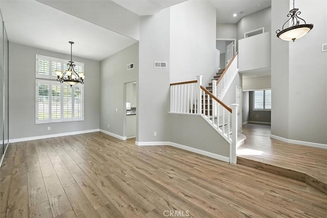 25623 Frost Ln, Stevenson Ranch, CA 91381 - entrance foyer with wood finished floors, a high ceiling, a chandelier, and stairs