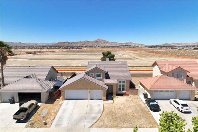 2659 Cold Creek Ave, Rosamond, CA 93560 - traditional home featuring concrete driveway, a garage, a tiled roof, stucco siding, and a mountain view