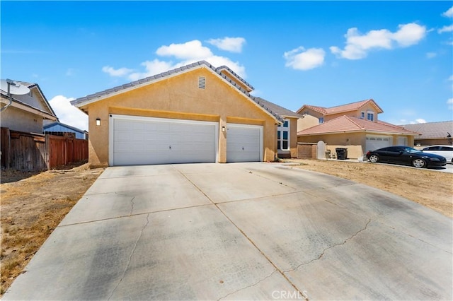 2659 Cold Creek Ave, Rosamond, CA 93560 - view of front of property featuring driveway, an attached garage, and stucco siding