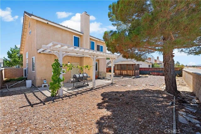 2659 Cold Creek Ave, Rosamond, CA 93560 - back of house featuring stucco siding, a patio, a pergola, and a fenced backyard