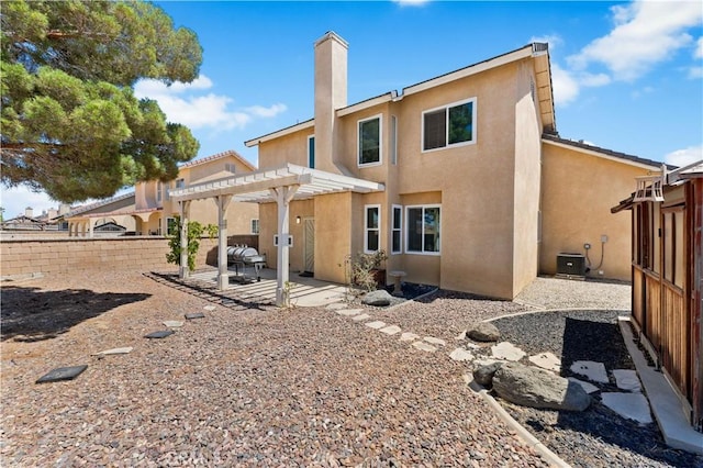 2659 Cold Creek Ave, Rosamond, CA 93560 - rear view of house featuring stucco siding, a pergola, a patio area, and a fenced backyard