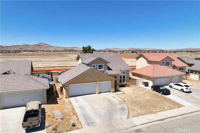 2659 Cold Creek Ave, Rosamond, CA 93560 - view of front of property featuring stucco siding, concrete driveway, a mountain view, a tile roof, and a garage