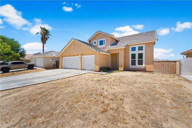 2659 Cold Creek Ave, Rosamond, CA 93560 - view of front of house featuring an attached garage, concrete driveway, stucco siding, and a tiled roof