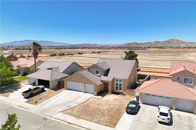 2659 Cold Creek Ave, Rosamond, CA 93560 - view of front of property featuring concrete driveway, a garage, a tiled roof, and a mountain view