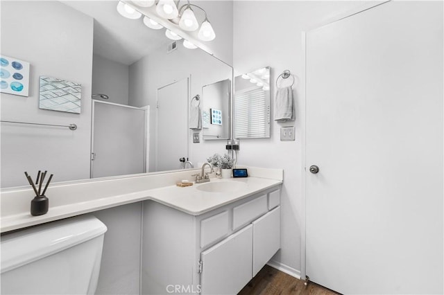 2659 Cold Creek Ave, Rosamond, CA 93560 - full bathroom featuring vanity, a shower with door, and wood finished floors