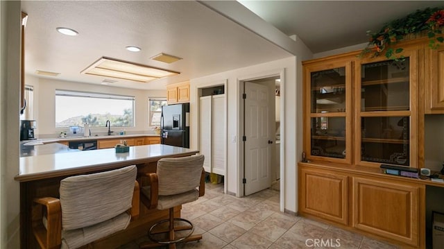 8920 Del Monte Ave, Yucca Valley, CA 92284 - kitchen featuring black refrigerator with ice dispenser, light countertops, a peninsula, dishwasher, and recessed lighting