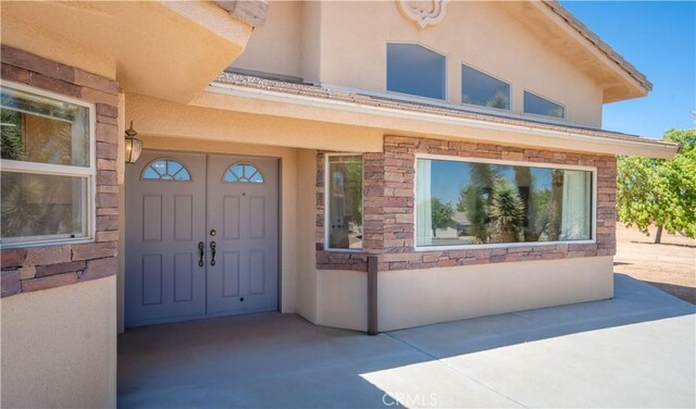 8920 Del Monte Ave, Yucca Valley, CA 92284 - doorway to property with stucco siding