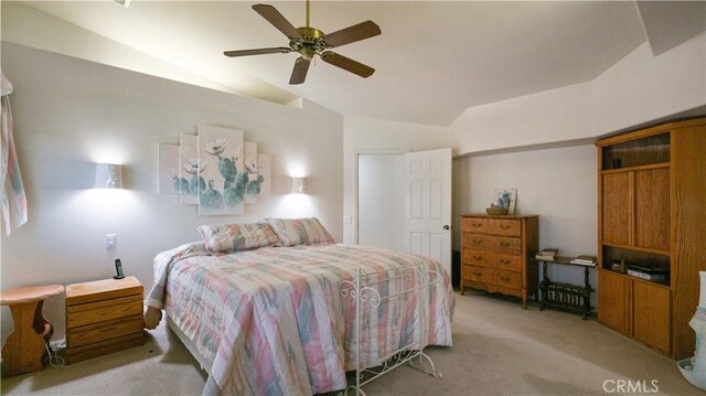 8920 Del Monte Ave, Yucca Valley, CA 92284 - bedroom featuring vaulted ceiling, light colored carpet, and ceiling fan
