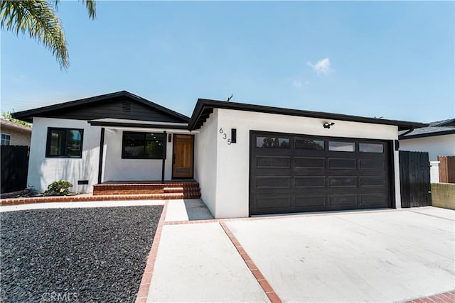 635 E 221st St, Carson, CA 90745 - view of front facade featuring a garage, concrete driveway, and stucco siding
