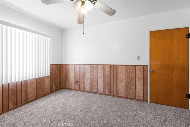1256 Windsor Dr, San Bernardino, CA 92404 - empty room with carpet, ceiling fan, wainscoting, and wooden walls