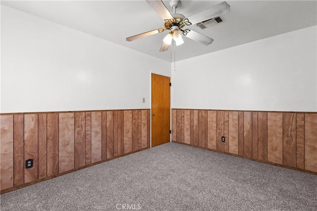 1256 Windsor Dr, San Bernardino, CA 92404 - unfurnished room with wainscoting, a ceiling fan, carpet flooring, and wooden walls