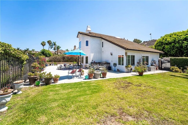 2151 Lyon Ave, Riverside, CA 92503 - rear view of house with a fenced backyard, stucco siding, a patio, and a chimney