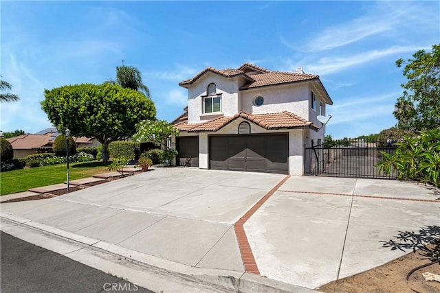 2151 Lyon Ave, Riverside, CA 92503 - mediterranean / spanish-style house with stucco siding, a tiled roof, driveway, and an attached garage