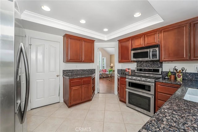 2151 Lyon Ave, Riverside, CA 92503 - kitchen featuring appliances with stainless steel finishes, crown molding, light tile patterned flooring, dark stone counters, and recessed lighting