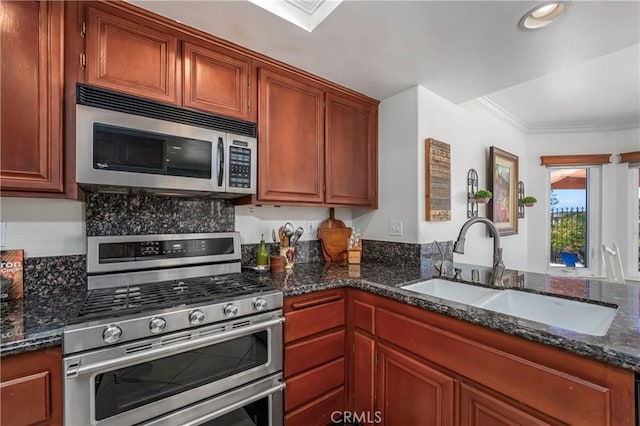 2151 Lyon Ave, Riverside, CA 92503 - kitchen featuring appliances with stainless steel finishes, dark stone countertops, ornamental molding, recessed lighting, and brown cabinets