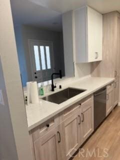 25715 Hogan Dr Unit B1, Valencia, CA 91355 - kitchen with dishwasher, light countertops, light wood-style flooring, and white cabinets