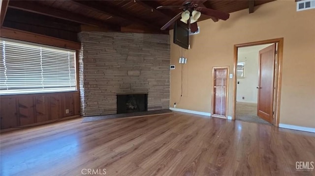 625 Cedar Ave, Wasco, CA 93280 - unfurnished living room with a wooden ceiling with exposed beams, a ceiling fan, wood finished floors, and a fireplace
