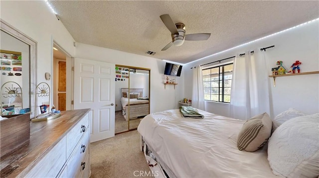 15233 Olive St, Hesperia, CA 92345 - bedroom with a textured ceiling, light colored carpet, a ceiling fan, and a closet